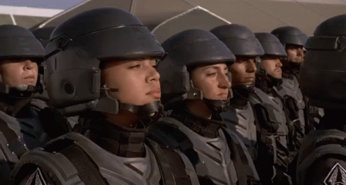 A Group Of Soldiers Are Standing In A Line With Their Eyes Closed And Their Helmets On GIF