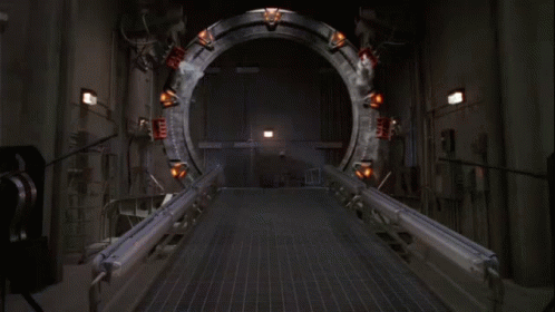 A Group Of Soldiers Are Standing In Front Of A Large Circular Object GIF
