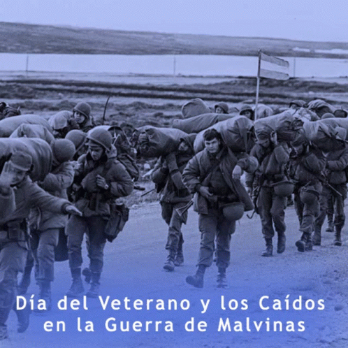 A Group Of Soldiers Are Walking Down A Road With The Words Dia Del Veterano Y Los Caidos GIF