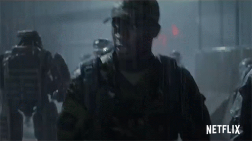 A Group Of Soldiers Are Walking In The Rain With A Netflix Logo In The Corner GIF