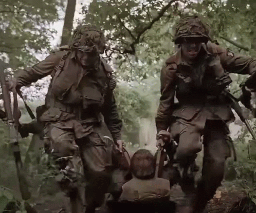 A Group Of Soldiers Carrying A Child In A Wheelchair GIF