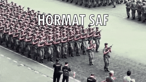 A Group Of Soldiers Marching Down A Street With Hormat Saf Written On The Bottom GIF