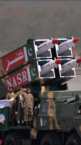 A Group Of Soldiers Stand In Front Of A Military Vehicle With Nasr Written On The Side GIF