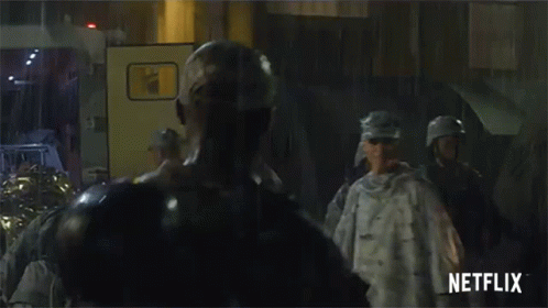 A Group Of Soldiers Standing In Front Of A Netflix Sign GIF