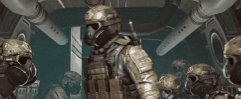 a group of soldiers wearing gas masks and helmets are in a room
