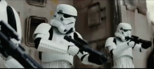 A Group Of Stormtroopers Are Holding Their Guns In A Line GIF
