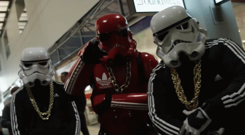 A Group Of Stormtroopers Wearing Adidas Jackets And Gold Chains GIF