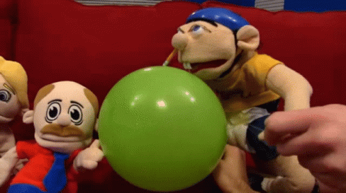 A Group Of Stuffed Animals Are Playing With A Green Balloon GIF