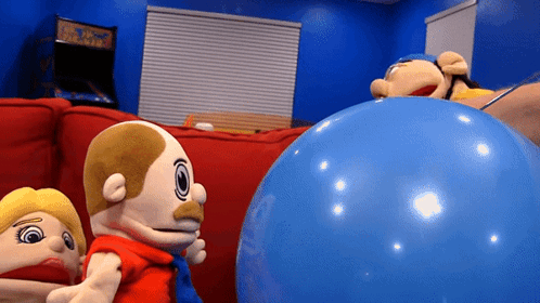 A Group Of Stuffed Animals Are Playing With A Large Blue Ball GIF