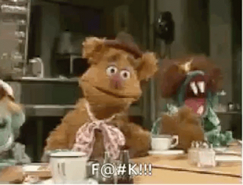 A Group Of Stuffed Animals Are Sitting At A Table With A Cup Of Coffee And A Teapot . GIF