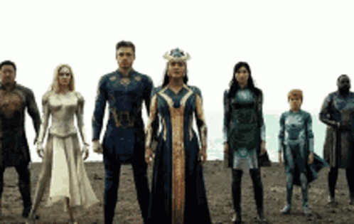 A Group Of Superhero Characters Standing Next To Each Other In A Line . GIF