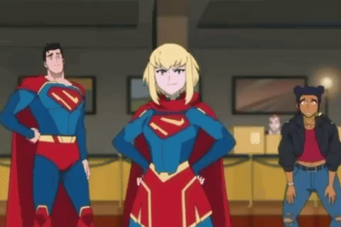 A Group Of Superheroes Are Standing Next To Each Other In A Room Giving Each Other A High Five . GIF