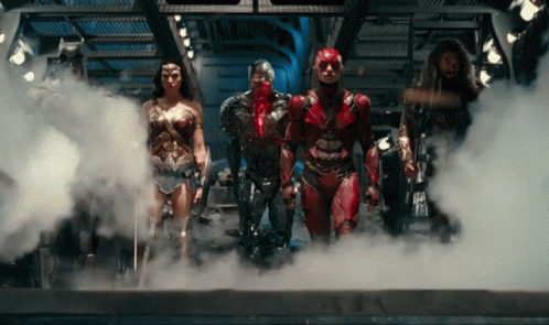 A Group Of Superheroes Standing In A Room With Smoke Coming Out Of Them GIF