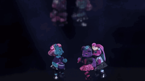 a group of teddy bears are dancing together in a dark room