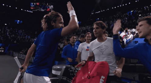 a group of tennis players high five each other in front of a scoreboard that says team europe