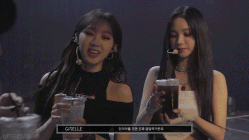 A Group Of Three Women Holding Drinks With T.m.i Written On The Bottom GIF