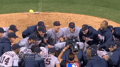 A Group Of Tigers Baseball Players Huddle Together GIF