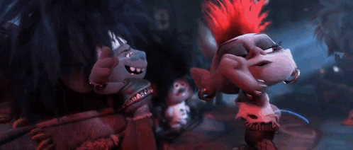 A Group Of Trolls Are Standing Next To Each Other In A Dark Room And Singing . GIF