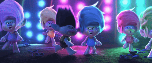 A Group Of Trolls Are Standing Next To Each Other On A Stage Dancing . GIF