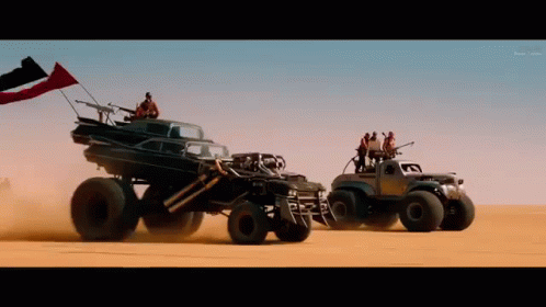 A Group Of Vehicles Are Driving Through The Desert GIF