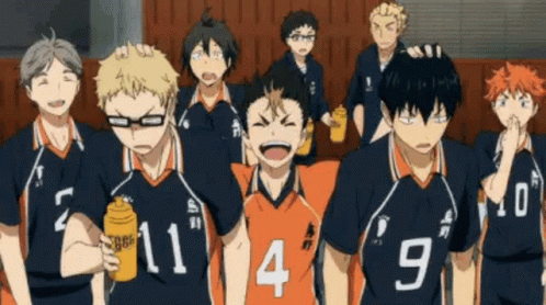 A Group Of Volleyball Players Are Standing Next To Each Other In A Gym . GIF