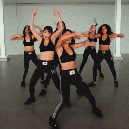 A Group Of Women Are Dancing And One Has The Number 10 On Her Top GIF