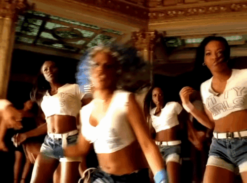 a group of women are dancing and one of them is wearing a shirt that says ' u.y. girls '