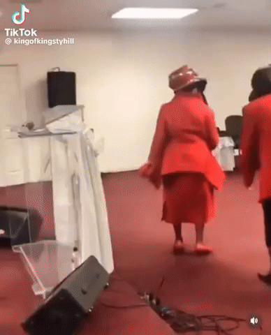 A Group Of Women Are Dancing In A Church . GIF