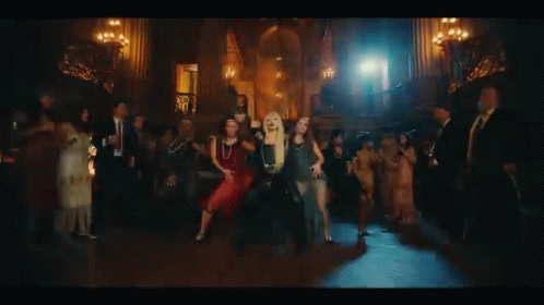A Group Of Women Are Dancing In A Dark Room In Front Of A Castle . GIF