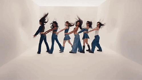 A Group Of Women Are Dancing In A Line With Their Hair Flying In The Air GIF