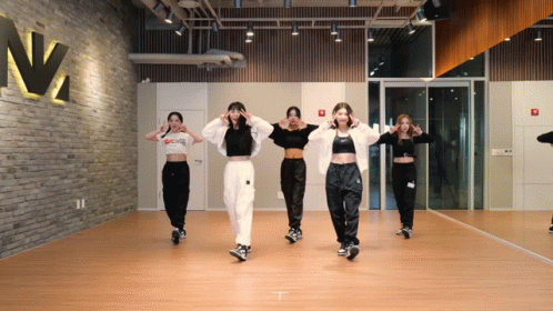 A Group Of Women Are Dancing In Front Of A Mirror In A Dance Studio With A Sign That Says N2 On It GIF