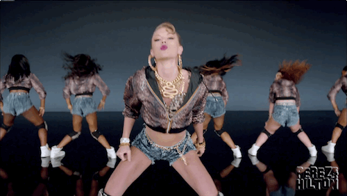 A Group Of Women Are Dancing In Front Of A Screen That Says ' Freak Hilton ' On It GIF