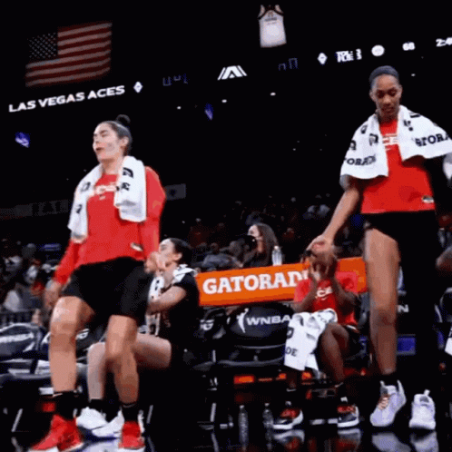 A Group Of Women Are Dancing On A Basketball Court In Front Of A Banner That Says Gatorade GIF