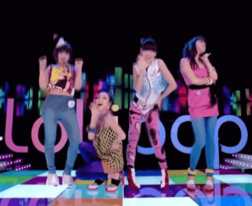 A Group Of Women Are Dancing On A Colorful Dance Floor With The Word Lollipop In The Background GIF