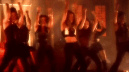 Women Dancing On Stage In Dark Room GIF