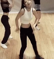A Group Of Women Are Dancing On A Wooden Floor In A Room . GIF