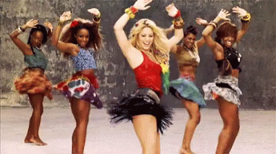 a group of women are dancing together in a line