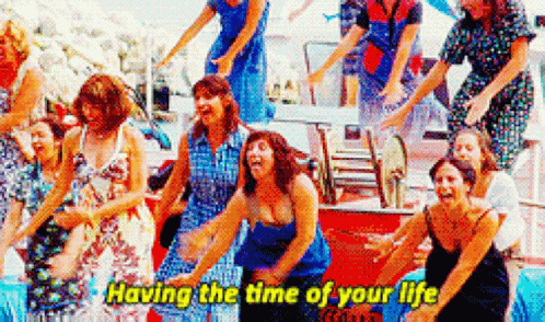 A Group Of Women Are Dancing Together With The Words `` Having The Time Of Your Life '' Written On The Bottom . GIF