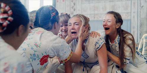 A Group Of Women Are Laughing And One Of Them Is Crying With Her Mouth Open GIF