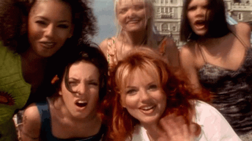 A Group Of Women Are Posing For A Picture Together And Smiling For The Camera . GIF