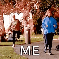 A Group Of Women Are Running Down A Sidewalk In A Park With The Words `` Me '' Written On It . GIF