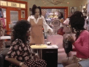 a group of women are sitting in a room with a sign that says ' exit ' on it
