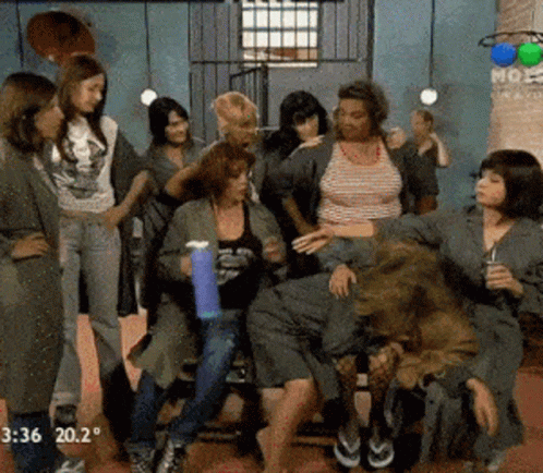 A Group Of Women Are Standing And Sitting In A Room With The Time Of 3:36 GIF