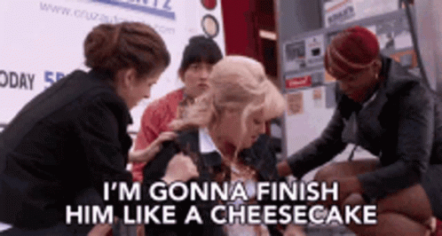 A Group Of Women Are Standing Around A Woman Who Says I 'M Gonna Finish Him Like A Cheesecake .. GIF