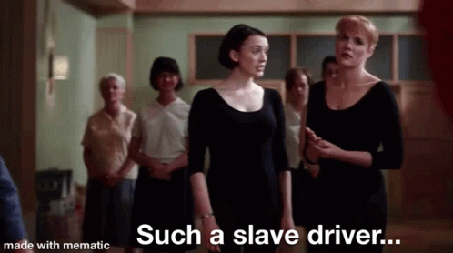 A Group Of Women Are Standing In A Room Talking To Each Other . GIF