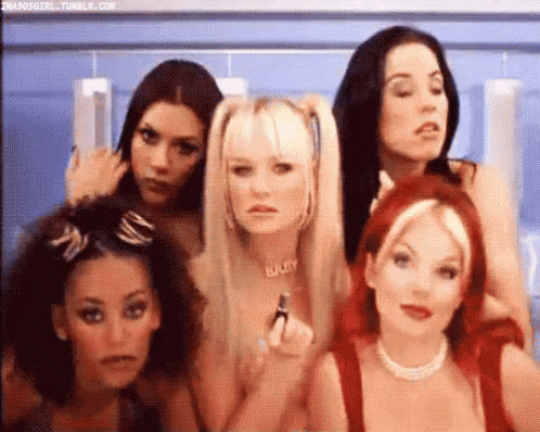 A Group Of Women Are Standing Next To Each Other . GIF