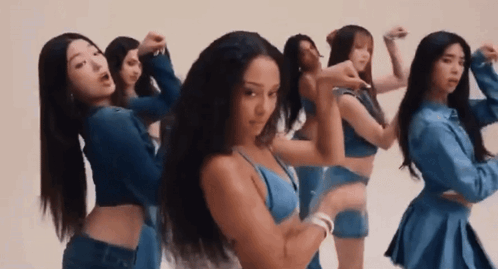 A Group Of Women Are Standing Next To Each Other And Dancing In Front Of A White Background . GIF