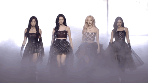 A Group Of Women Are Standing Next To Each Other In A Foggy Area GIF