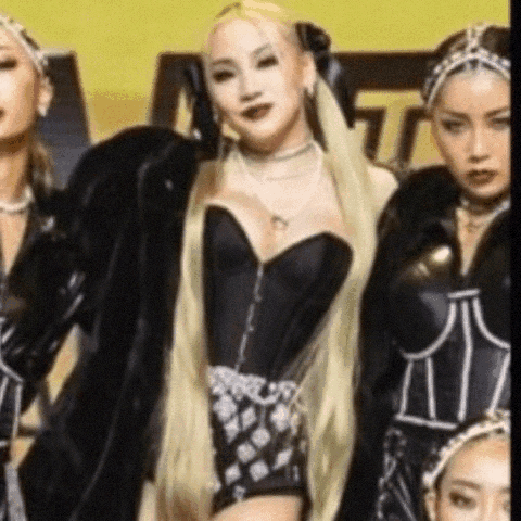 A Group Of Women Are Standing Next To Each Other In A Room . One Of The Women Is Wearing A Black Corset . GIF