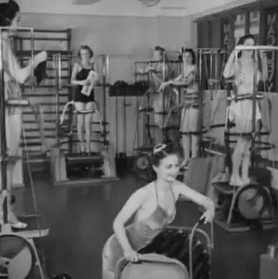 A Group Of Women Are Working Out In A Gym . GIF
